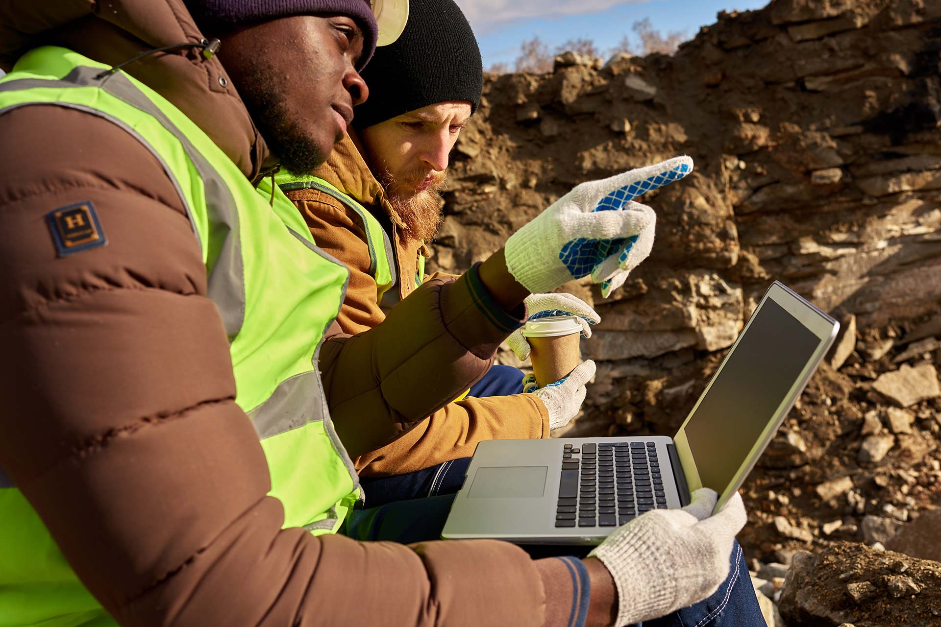 mining-workers-using-laptop-on-excavation-site-2023-11-27-05-09-16-utc.jpg